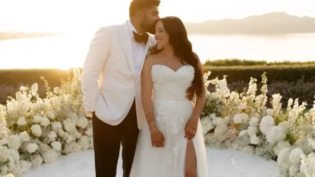 a bride and groom with a beautiful sea view background in greece