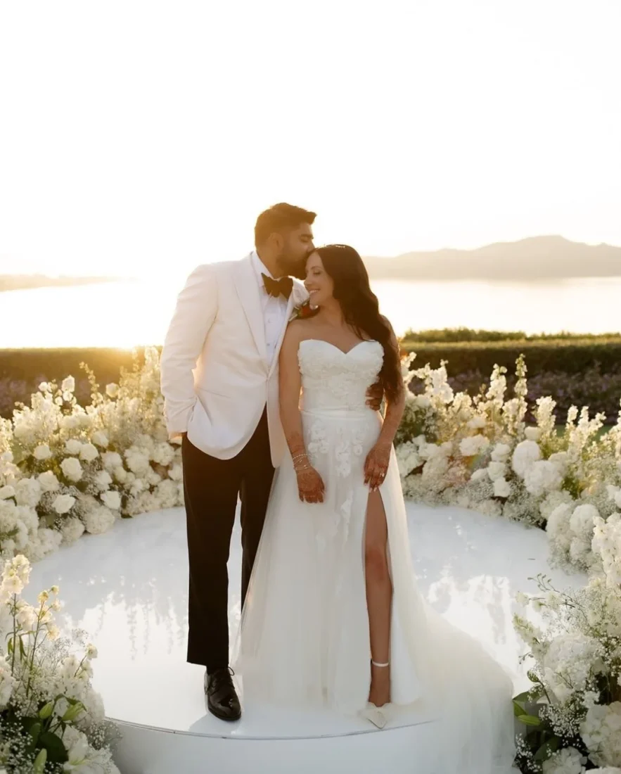 a bride and groom with a beautiful sea view background in greece