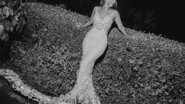 a bride in black and white photo on the beach