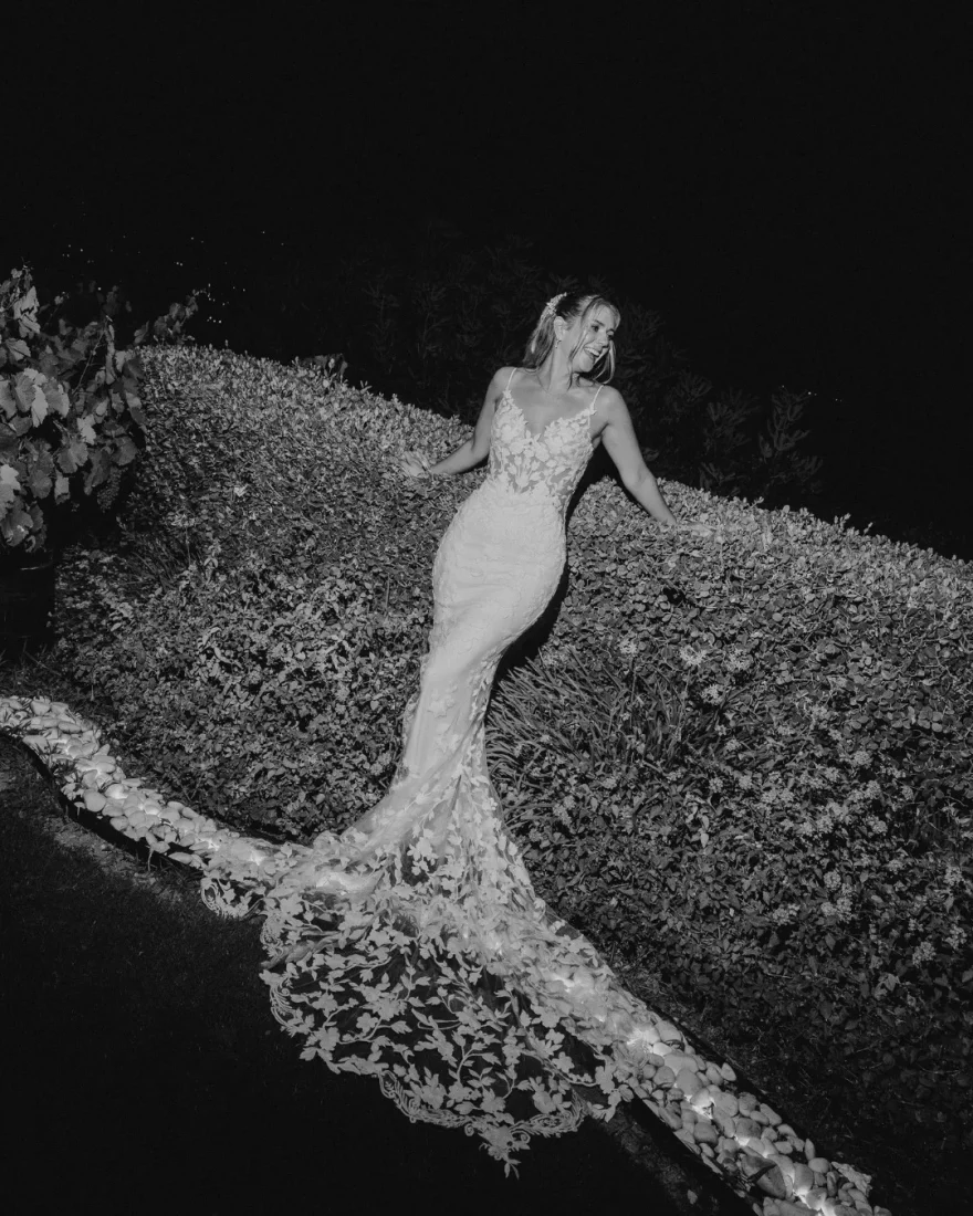a bride in black and white photo on the beach