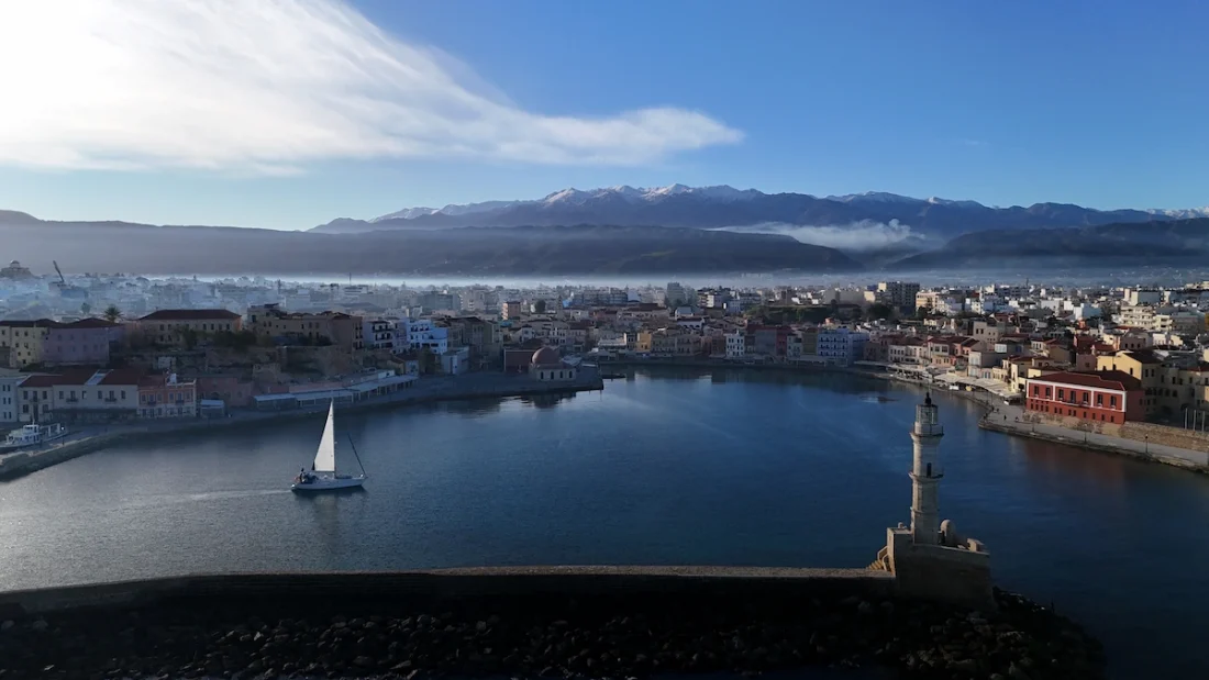 Sunrise in Chania, Crete with the snow-capped mountains in the background.