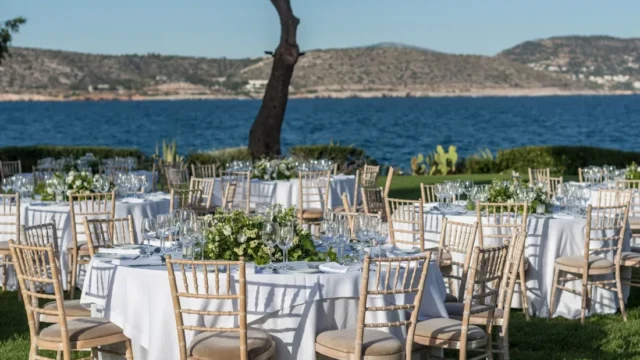 island residence wedding venue on the athens riviera at night tables set for a wedding