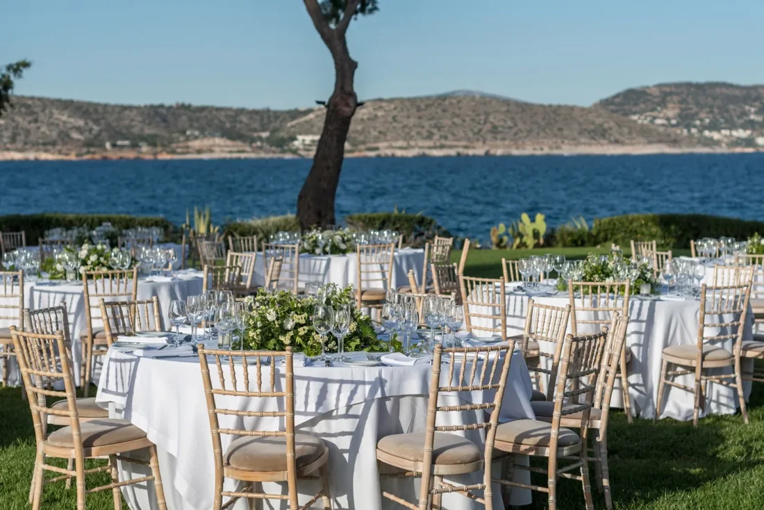 island residence wedding venue on the athens riviera at night tables set for a wedding