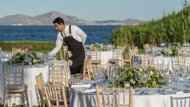 island residence wedding venue on the athens riviera at night a caterer preparing tables