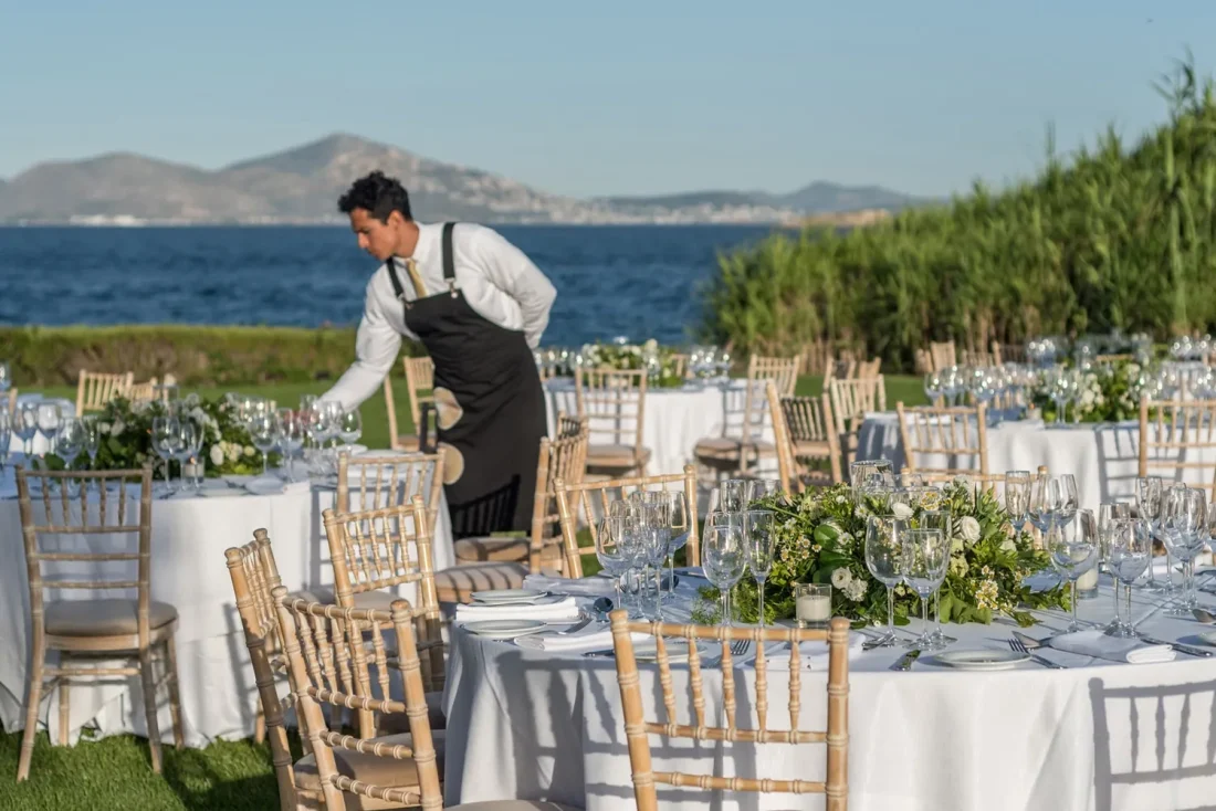 island residence wedding venue on the athens riviera at night a caterer preparing tables