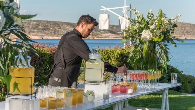 island residence wedding venue on the athens riviera at night barman serving