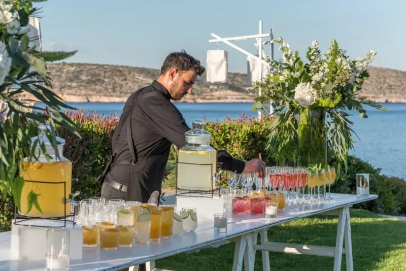 island residence wedding venue on the athens riviera at night barman serving