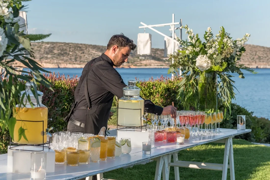 island residence wedding venue on the athens riviera at night barman serving