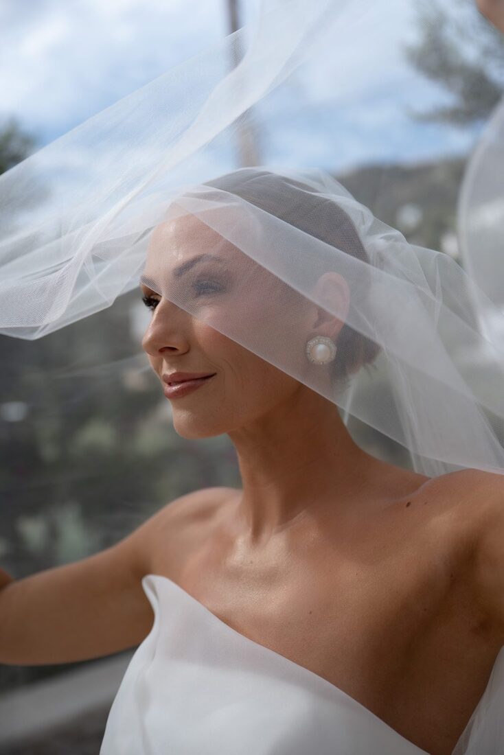 Bride's portrait under her veil with a pearl earring at a Sifnos wedding