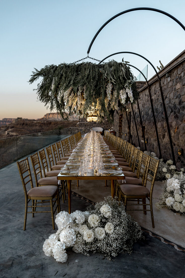Ceremony arch and table setting overlooking the caldera at Cavo Ventus, Santorini