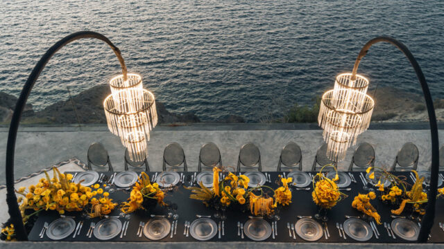 Dinner tables with hanging chandeliers and flowers at Cavo Ventus, Santorini