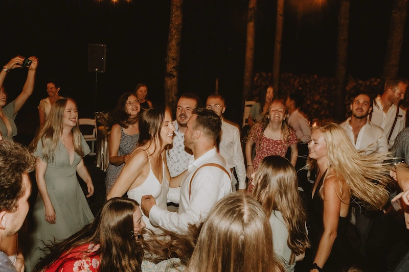 late night dancing crowd at a greek wedding