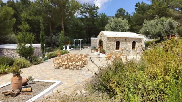 Chairs set for a ceremony outside the stone chapel at Kaminari Village, Rhodes
