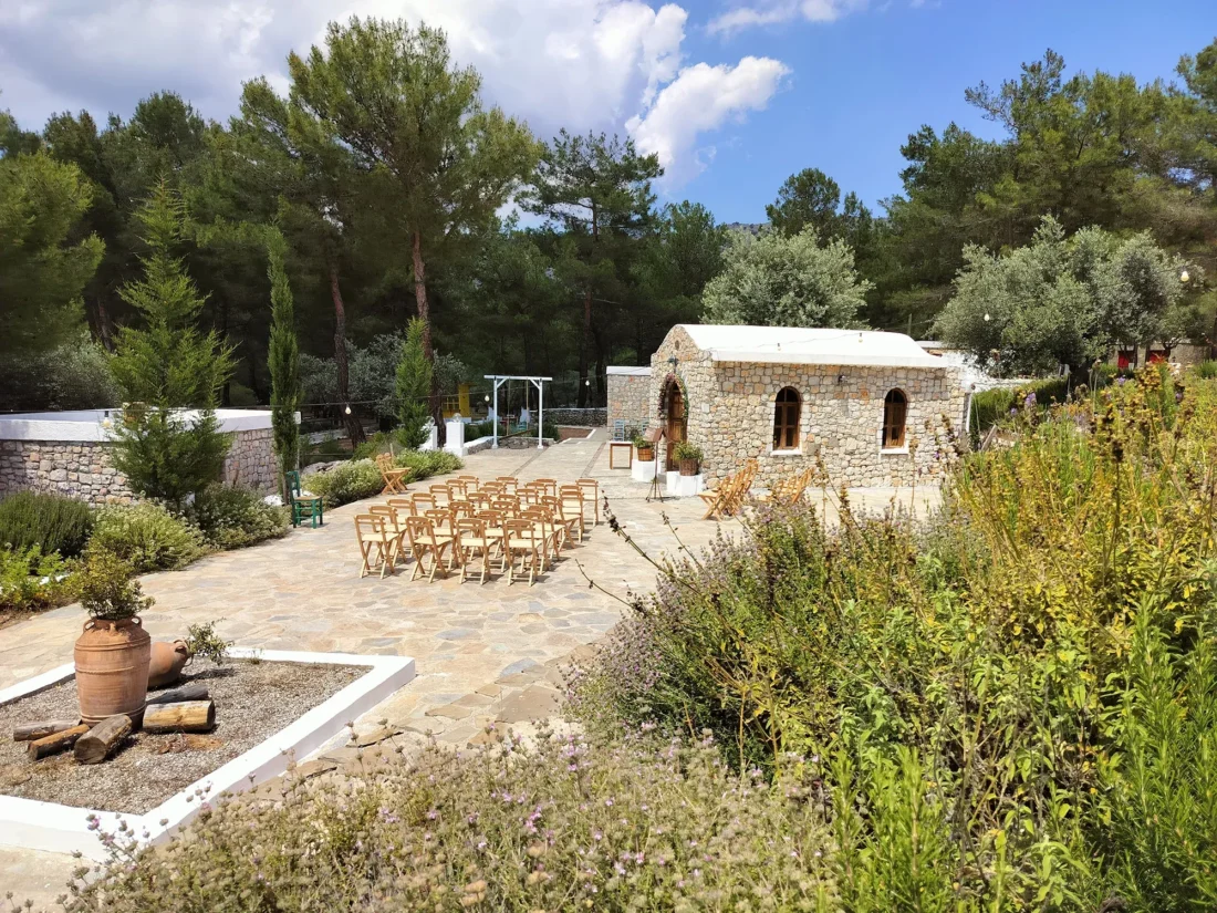 Chairs set for a ceremony outside the stone chapel at Kaminari Village, Rhodes