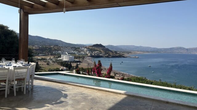 Pergola dining beside the infinity pool overlooking the bay at Ktima Lindos, Rhodes