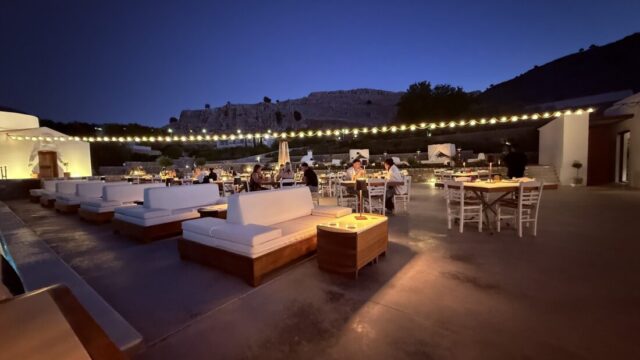 Lounge sofas and dining tables lit at night at Ktima Lindos, Rhodes