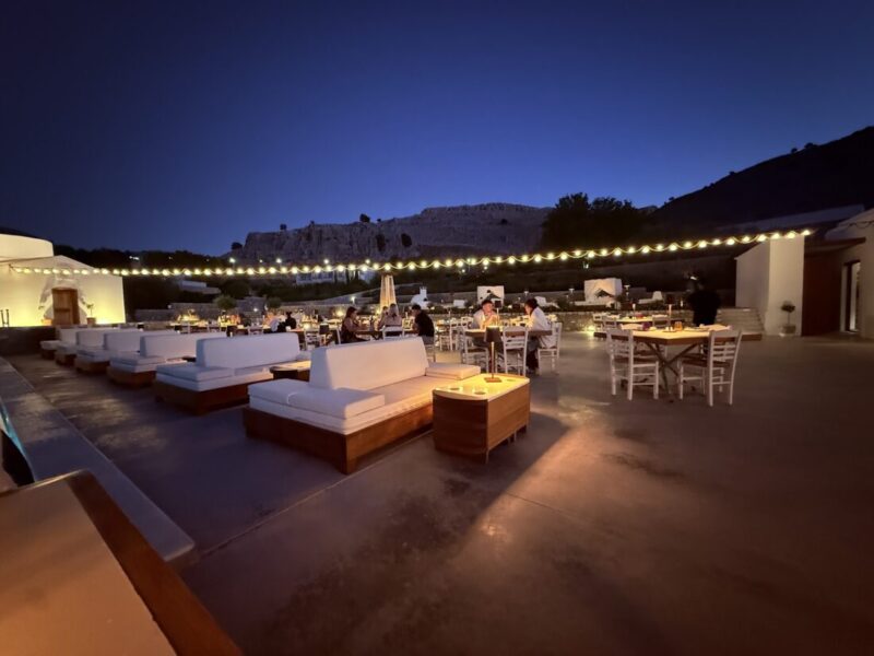 Lounge sofas and dining tables lit at night at Ktima Lindos, Rhodes
