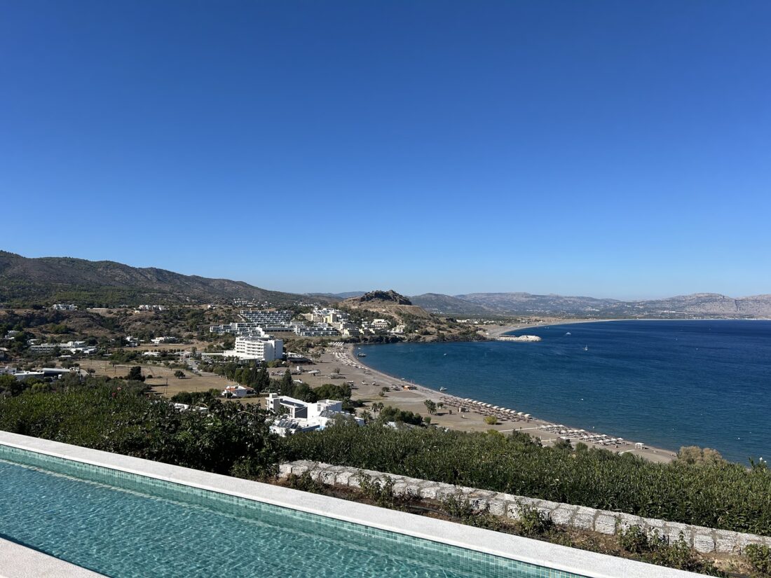 The infinity pool edge looking over Vlicha bay towards Lindos at Ktima Lindos