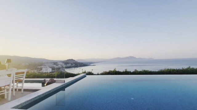 The infinity pool at dusk overlooking the bay at Ktima Lindos, Rhodes