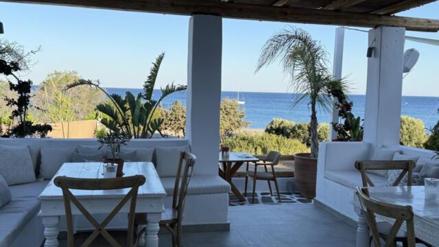Covered terrace with dining tables and sea views at Lythos, Rhodes