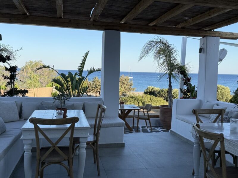 Covered terrace with dining tables and sea views at Lythos, Rhodes