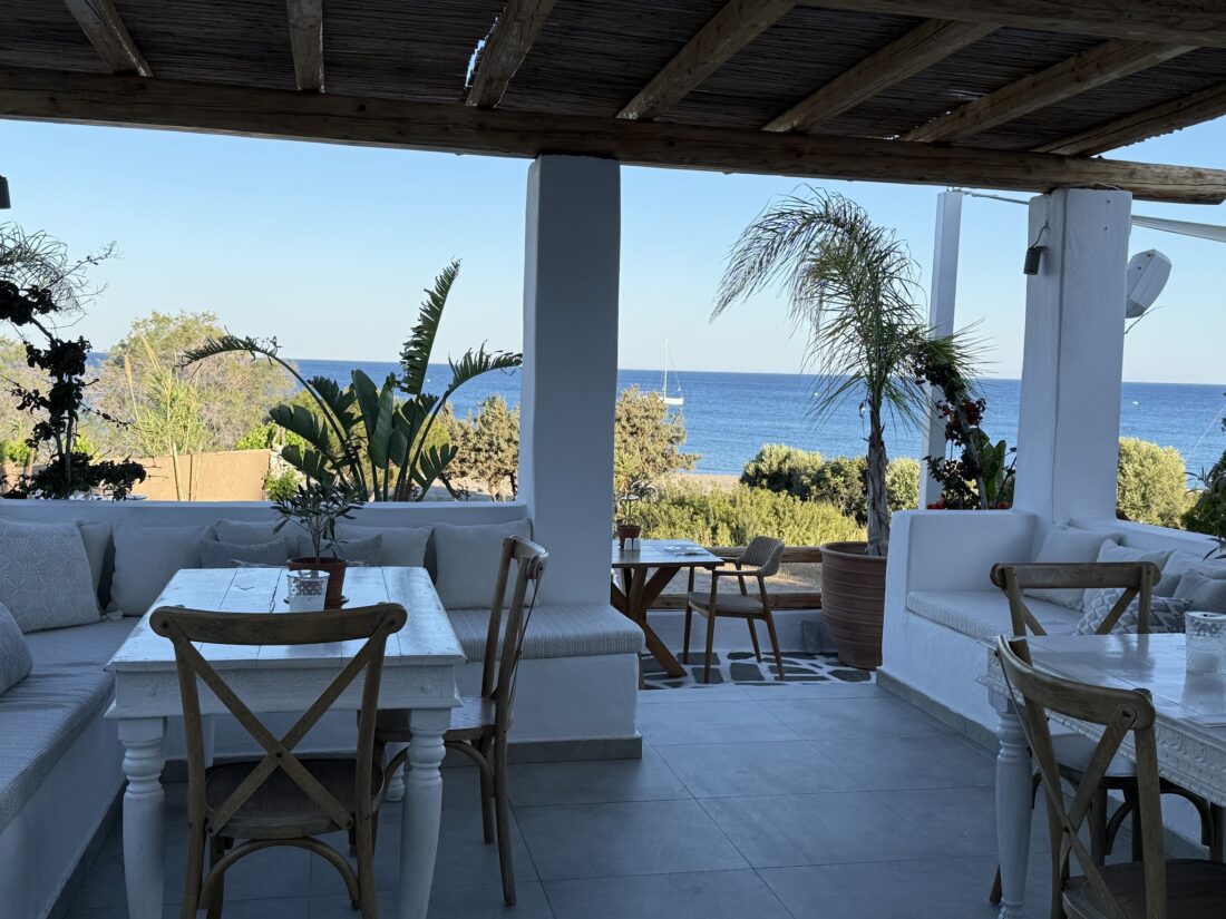 Covered terrace with dining tables and sea views at Lythos, Rhodes