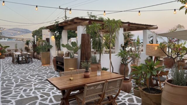 Open air dining terrace under festoon lights at Lythos, Kiotari, Rhodes