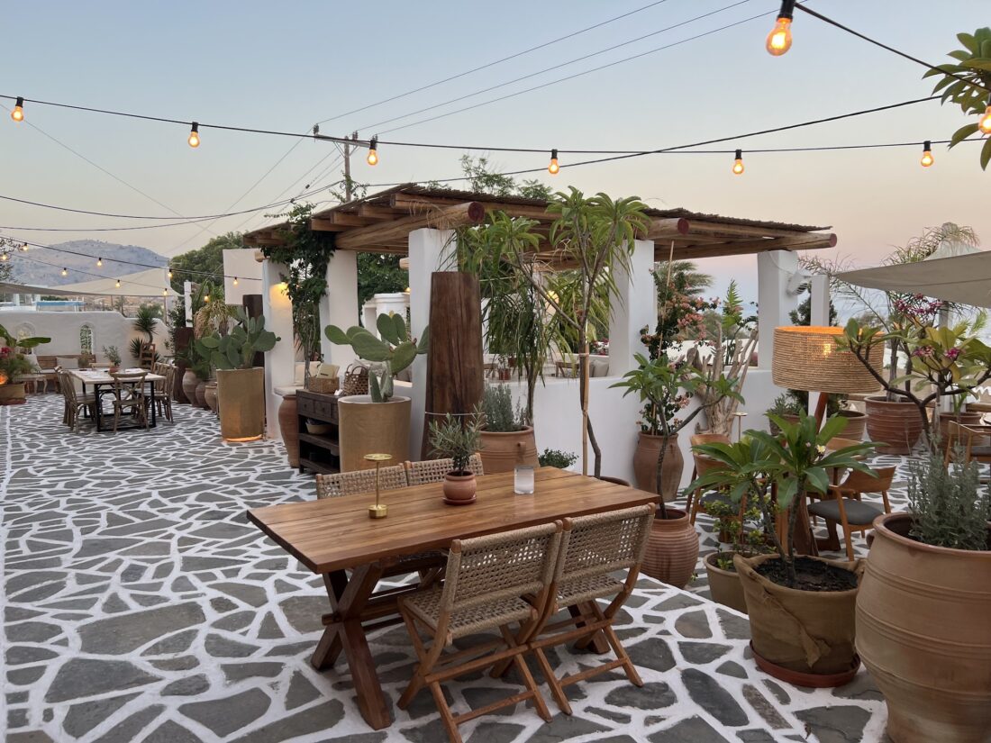 Open air dining terrace under festoon lights at Lythos, Kiotari, Rhodes