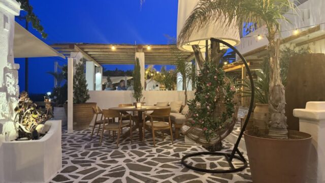 Evening terrace with palms under a deep blue sky at Lythos, Rhodes