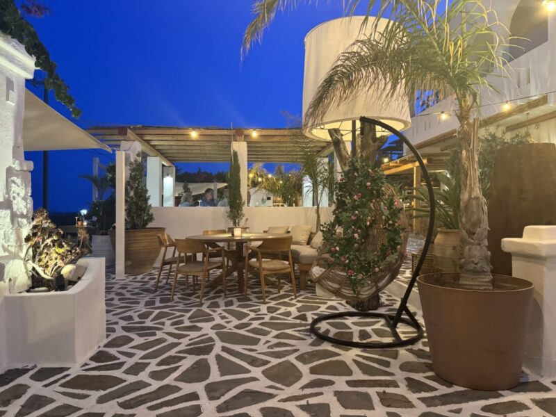 Evening terrace with palms under a deep blue sky at Lythos, Rhodes