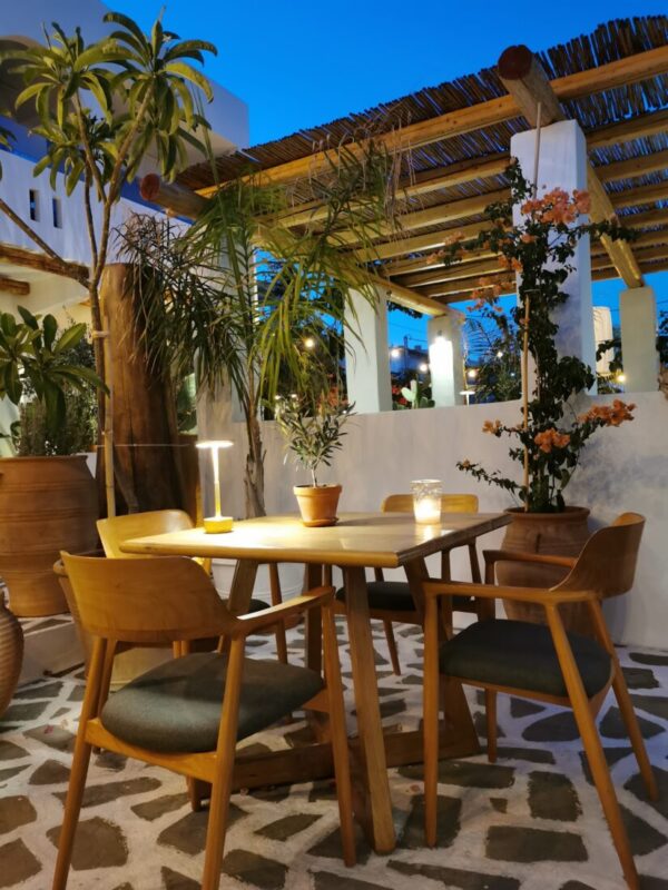 Pergola dining area with palms and sea views at Lythos, Rhodes