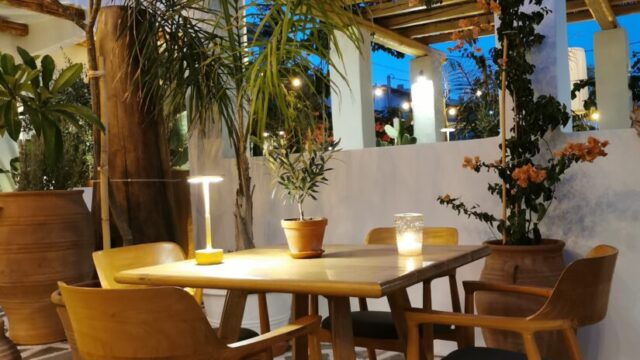 Pergola dining area with palms and sea views at Lythos, Rhodes