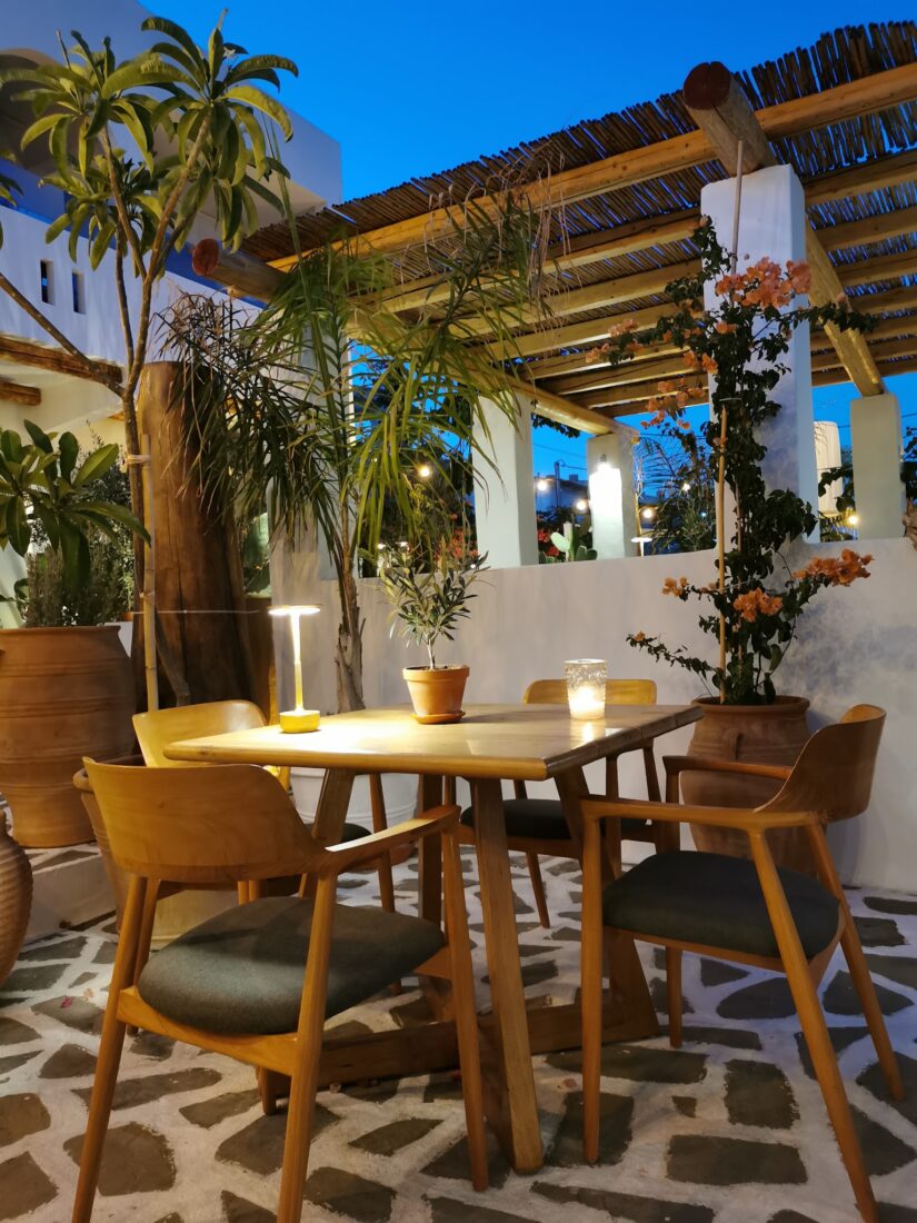 Pergola dining area with palms and sea views at Lythos, Rhodes