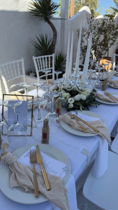 Wedding table set with white linen and greenery at Lythos, Rhodes