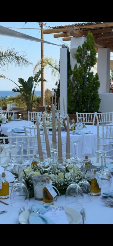 Wedding tables dressed in white beside the sea at Lythos, Kiotari, Rhodes