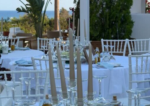 Wedding tables dressed in white beside the sea at Lythos, Kiotari, Rhodes