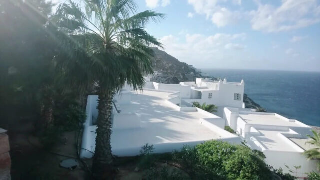 Whitewashed resort buildings above the sea at Royal Myconian, Elia Beach, Mykonos