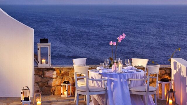 Evening event tables set beside the sea at Royal Myconian, Mykonos