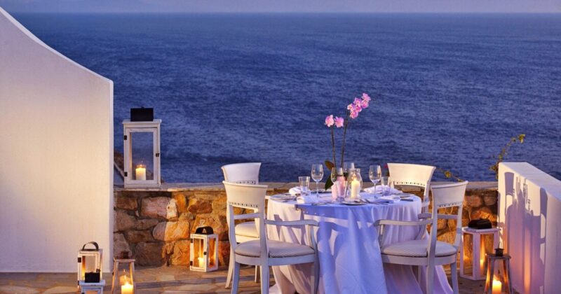 Evening event tables set beside the sea at Royal Myconian, Mykonos