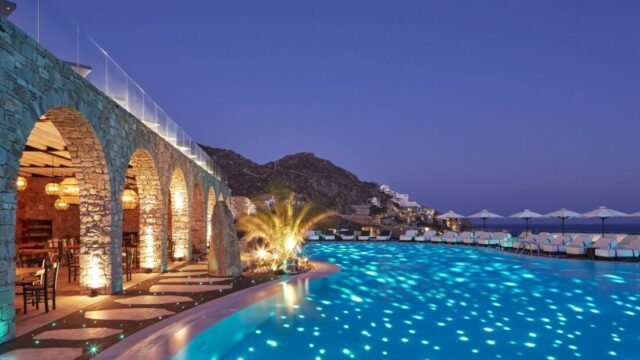 The lit main pool at night at Royal Myconian, Elia Beach, Mykonos