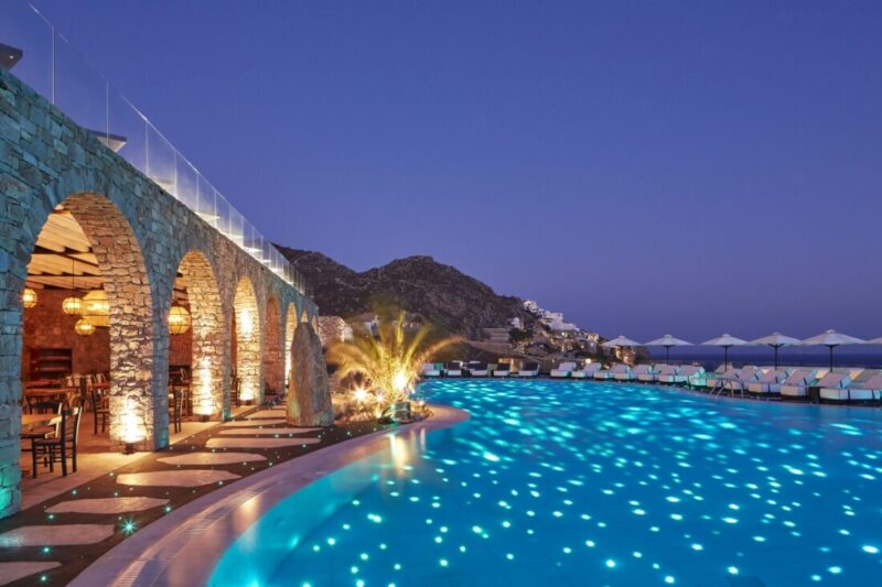 The lit main pool at night at Royal Myconian, Elia Beach, Mykonos