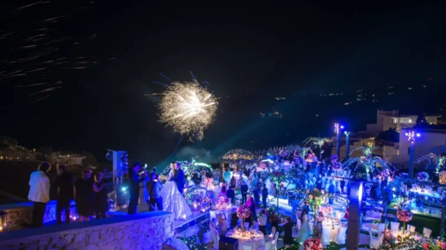 Evening wedding reception with fireworks over the sea at Royal Myconian, Mykonos