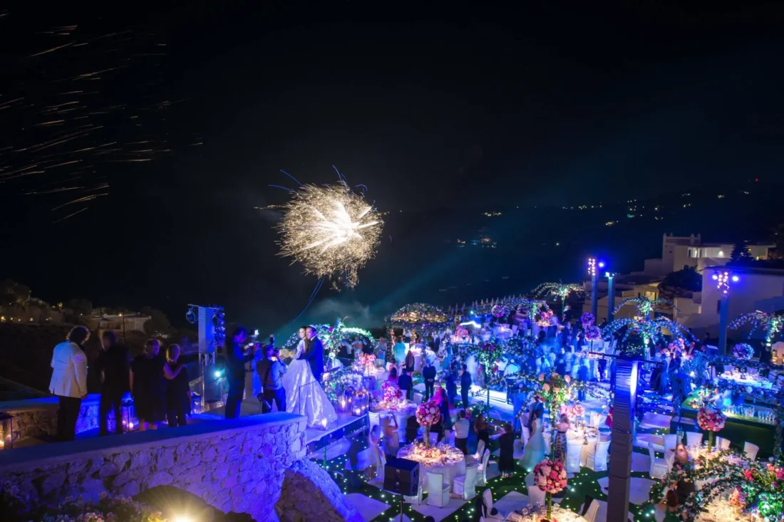 Evening wedding reception with fireworks over the sea at Royal Myconian, Mykonos